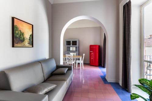 a living room with a couch and a red refrigerator at Palazzo Giangreco Luxury Rooms in Avola