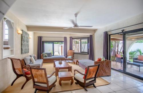 a living room with chairs and a table at Villa Céleste - 4 Bedrooms in Central Tamarin in Tamarin