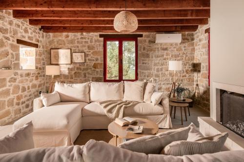 a living room with a couch and a fireplace at Geracasa Stone Villa in Méson Yerakaríon