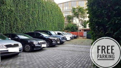 a row of cars parked in a parking lot at Hotel Alexis in Cluj-Napoca