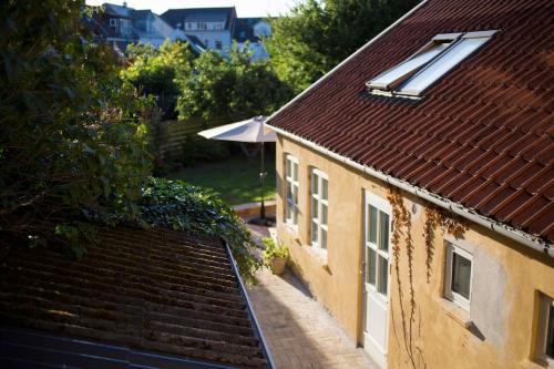 an overhead view of a house with a roof at Townhouse with private garden in the centre in Odense