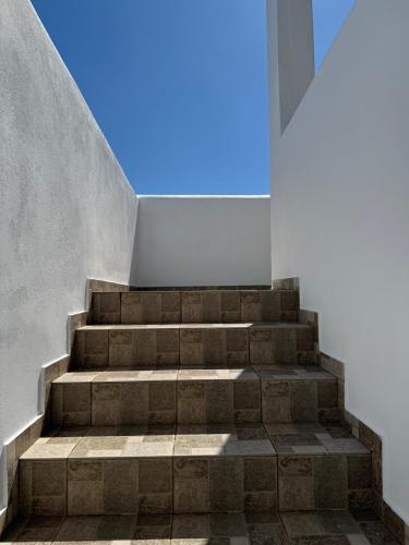 a staircase in a building with the sky in the background at Tinos beauty village in Kalloní