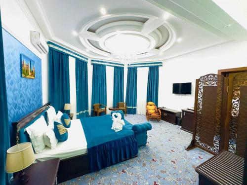 a bedroom with a bed and a room with blue curtains at Garden Boutique Hotel in Bukhara