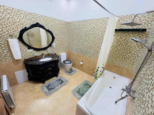 a bathroom with a sink and a mirror at Garden Boutique Hotel in Bukhara