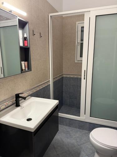 a bathroom with a sink and a shower at Tinos beauty village in Kalloní