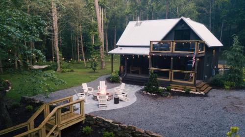 an aerial view of a log cabin with a table and chairs at Riverstone Cottage A Cozy Riverfront Retreat in Dahlonega