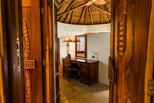 a hallway with a desk and a ceiling at Premier Resort Mpongo Private Game Reserve in Macleantown