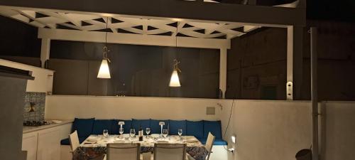 a dining room with a table and chairs and lights at La Casa del Moro in Favignana