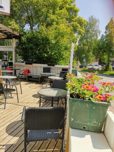 a patio with tables and chairs and flowers at Hotel Turistihovi in Kouvola