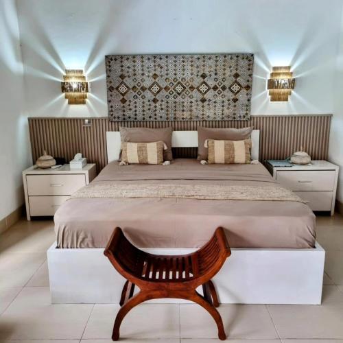 a bedroom with a large bed and two night stands at Villa Casa Jamika in Seminyak