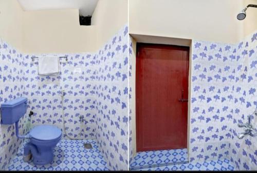 a bathroom with a blue toilet and a red door at HOME STAY MAHALI 2bhk villa NEAR ROCK BEACH in Puducherry