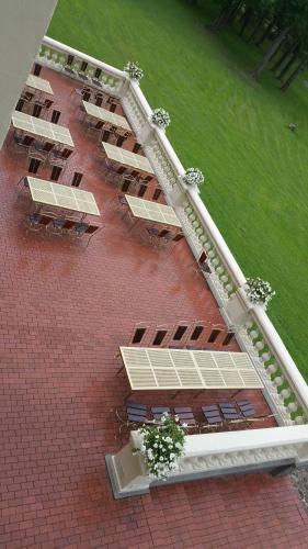 an overhead view of a building with tables and benches at Taujėnų dvaro rūmai in Towiany