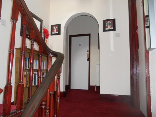 an archway leading to a hallway with books at All Seasons Guest House in Great Yarmouth