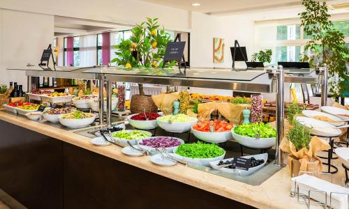 a buffet with many bowls of food on a table at Aminess Vival Velaris Resort in Supetar