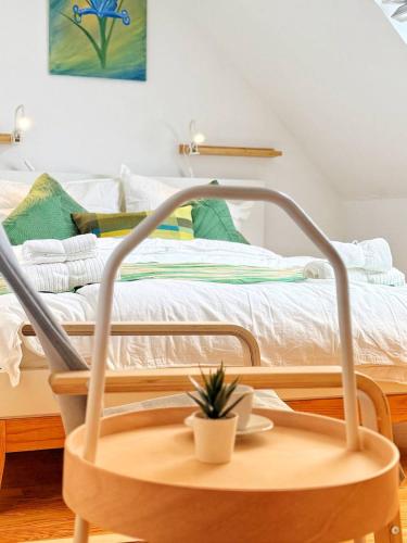 a hospital bed with a table with a plant on it at Stilvolle Maisonette in Neuss - Balkon & Gratis-Parkplatz in Neuss