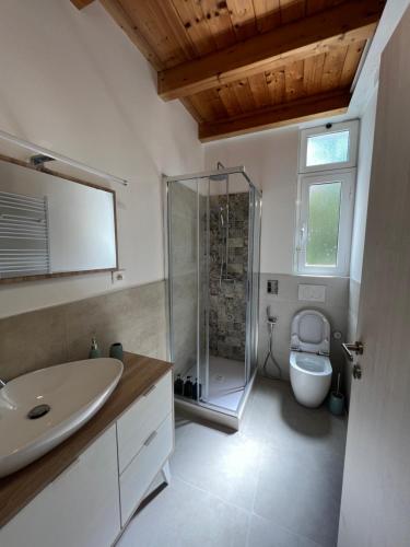 a bathroom with a shower and a sink and a toilet at Appartamento con accesso privato spiaggia in Savona
