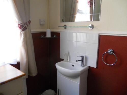 a bathroom with a sink and a mirror at All Seasons Guest House in Great Yarmouth