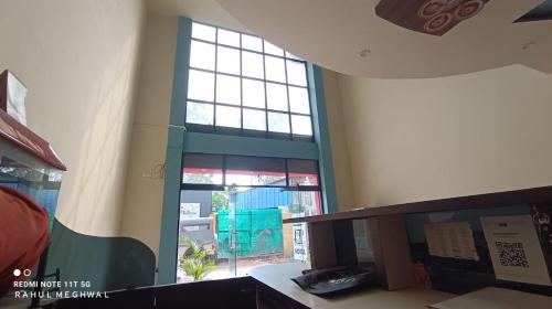 an empty room with a large window in a building at Shahi Palace Hotel in Nāthdwāra