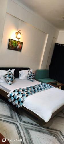 a bedroom with a large bed with pillows on it at Shahi Palace Hotel in Nāthdwāra