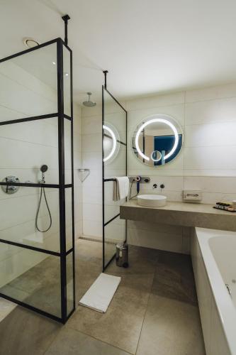 a bathroom with a sink and a mirror at Van der Valk Hotel Den Haag in Nootdorp