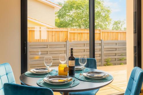 a table with two glasses and a bottle of wine at Évasion balnéo, terrasse, parking, plage - 4 pers in Arès
