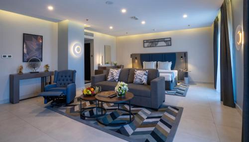 a living room with a couch and a bed at Hotel Holiday International in Sharjah