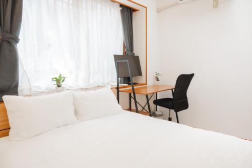 Postel nebo postele na pokoji v ubytování Okinawa Homie Stay