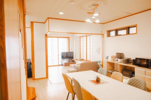 a living room with a white table and chairs at Okinawa Homie Stay in Naha