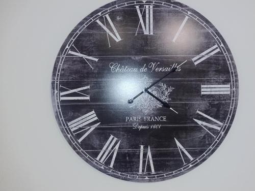 a large clock with the words permission of a paris palace at DHofstede vakantiewoning in Oudenaarde