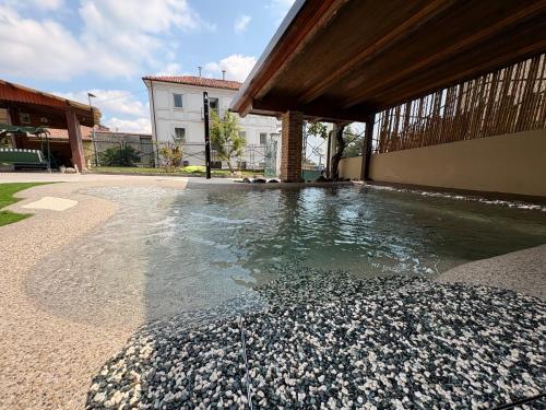 a pool of water in a courtyard with a building at ByVigin in Magliano Alfieri
