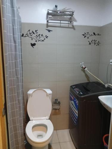a bathroom with a toilet and a sink at AA's Property in Sampong