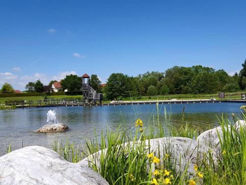 a fountain in the middle of a pond at Berghamer's Gasthof Hotel in Neukirchen am Walde