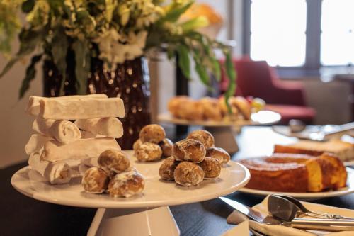 a table topped with two plates of pastries and bread at MS Collection Arouca - Mosteiro de Arouca in Arouca