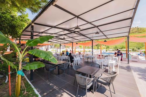 a restaurant with tables and chairs under a canopy at Edva Resort in Vlorë