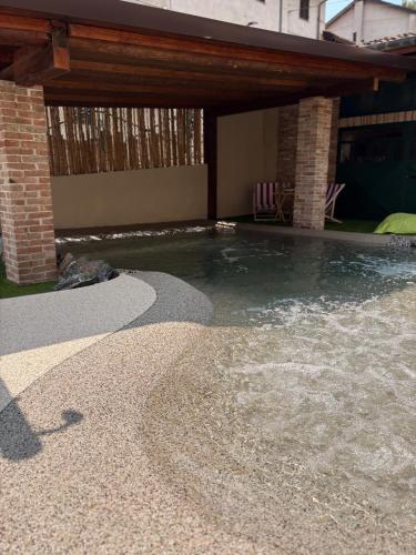 a pool of water in a backyard with a house at ByVigin in Magliano Alfieri