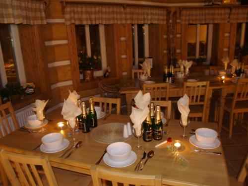 a wooden table with candles and napkins on it at Penzion Marienka in Pec pod Sněžkou