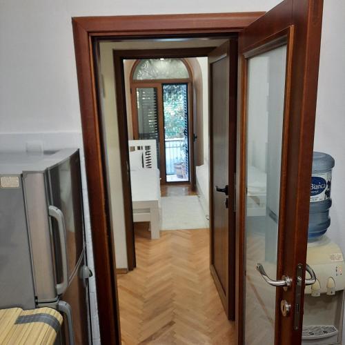 a door leading into a room with a hallway at Apartman HOME Kotor in Kotor
