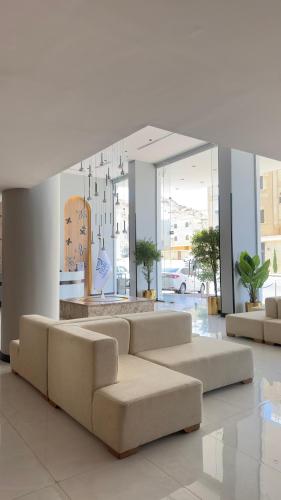 a living room with two couches in a lobby at فندق فيوري - المطار in Taif