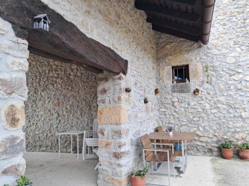 a stone building with a table and chairs in it at Casa rural la Venta in Bareyo