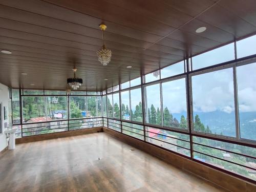 an empty room with a view of a mountain at Shriniz Hotel in Lava