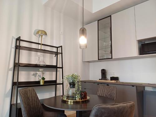 a kitchen with a table and chairs and a counter at Luise LuXe Suites in Tallinn