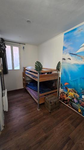 a room with two bunk beds and a mural at Appartement plage & port in Le Tréport