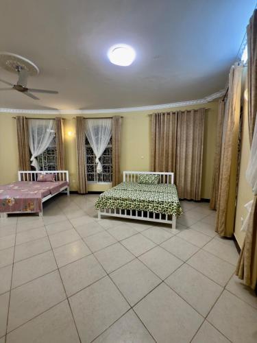 a large room with two beds in it at Chukwani palace in Zanzibar City