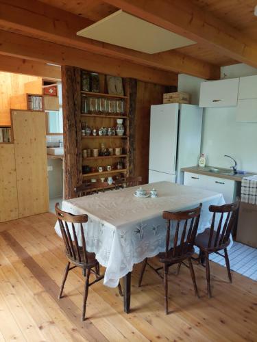 a kitchen with a table with chairs and a refrigerator at Vceli RAJ Bojnice in Bojnice