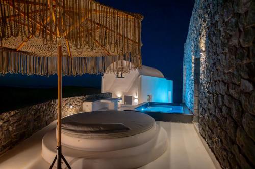 a white bathroom with a toilet in a room at San Nectar Luxury Villas in Vourvoulos