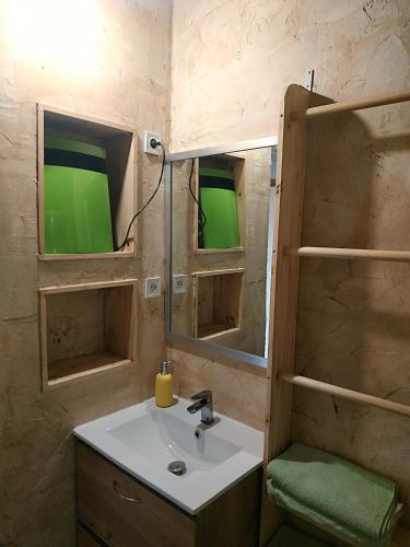 a bathroom with a sink and two mirrors at CROUXETO Chambres d'hôte in Duilhac