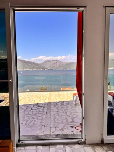 a door leading to a view of the ocean at Kamilica Apartman in Krasici