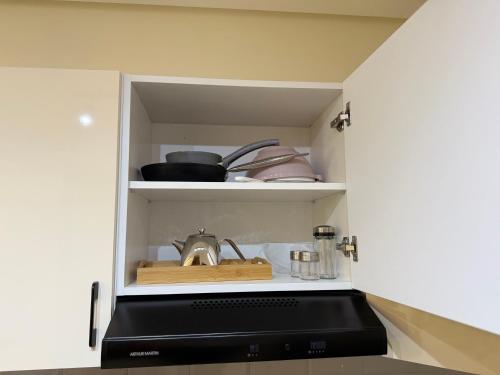 a cupboard with a stove top oven in a kitchen at Green Haven- Nature & Design - Riad Extension in Temara