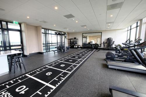 a gym with treadmills and exercise equipment in a building at Van der Valk Hotel Den Haag in Nootdorp