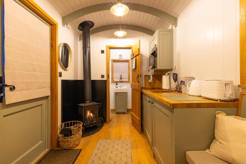 a kitchen with a stove in the middle of a room at Jasmine Hut in Bristol